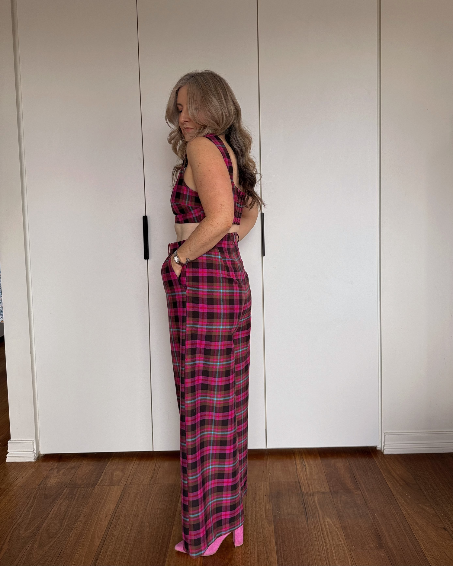 Model wearing The Tailored Crop by By Bel in a blush heritage tartan with a structured fit and square neckline.