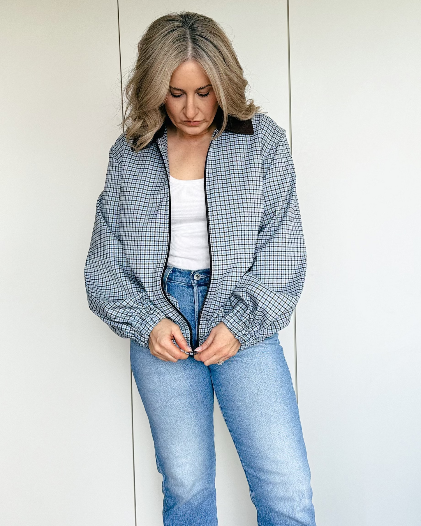 Model wearing The Tailored Bomber by By Bel in a powder blue heritage check with a contrast faux suede collar and relaxed silhouette.