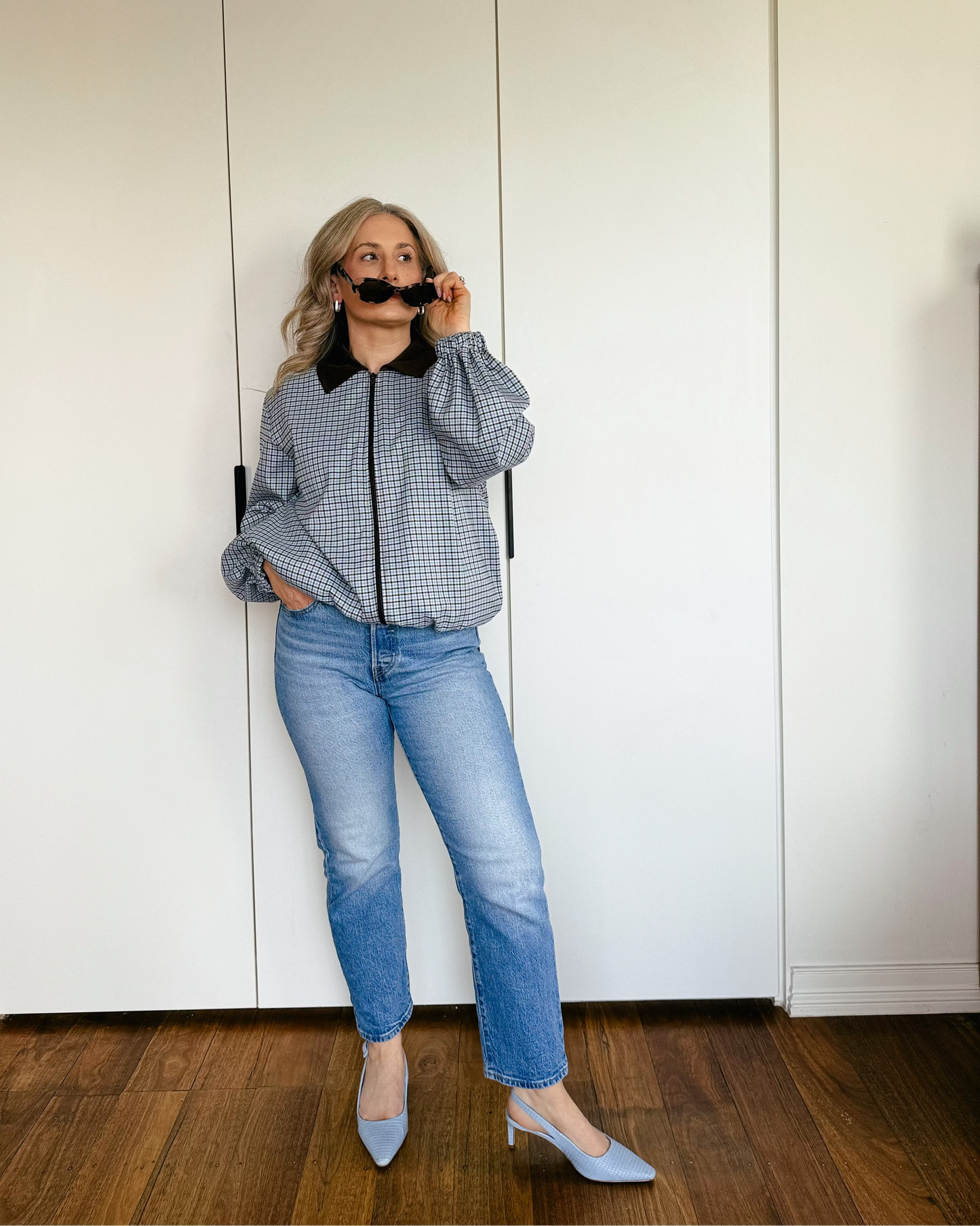 Model wearing The Tailored Bomber by By Bel in a powder blue heritage check with a contrast faux suede collar and relaxed silhouette.