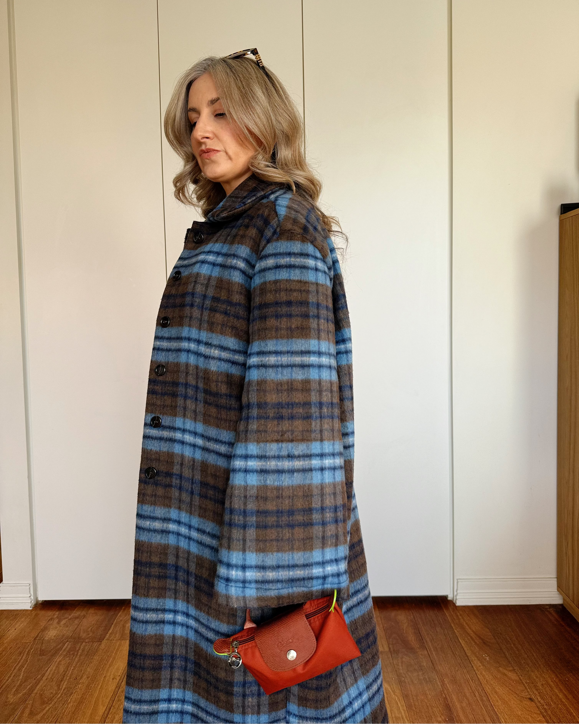 Model wearing The Tailored Coat by By Bel in an espresso and powder blue heritage check with a relaxed straight-cut silhouette