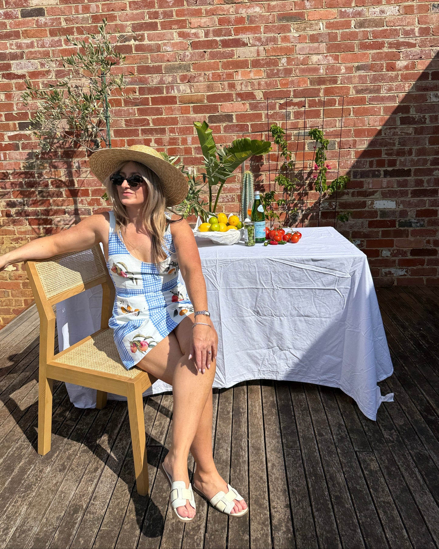 European summer outfit featuring lemon print mini dress styled for long lunch and aperitivo