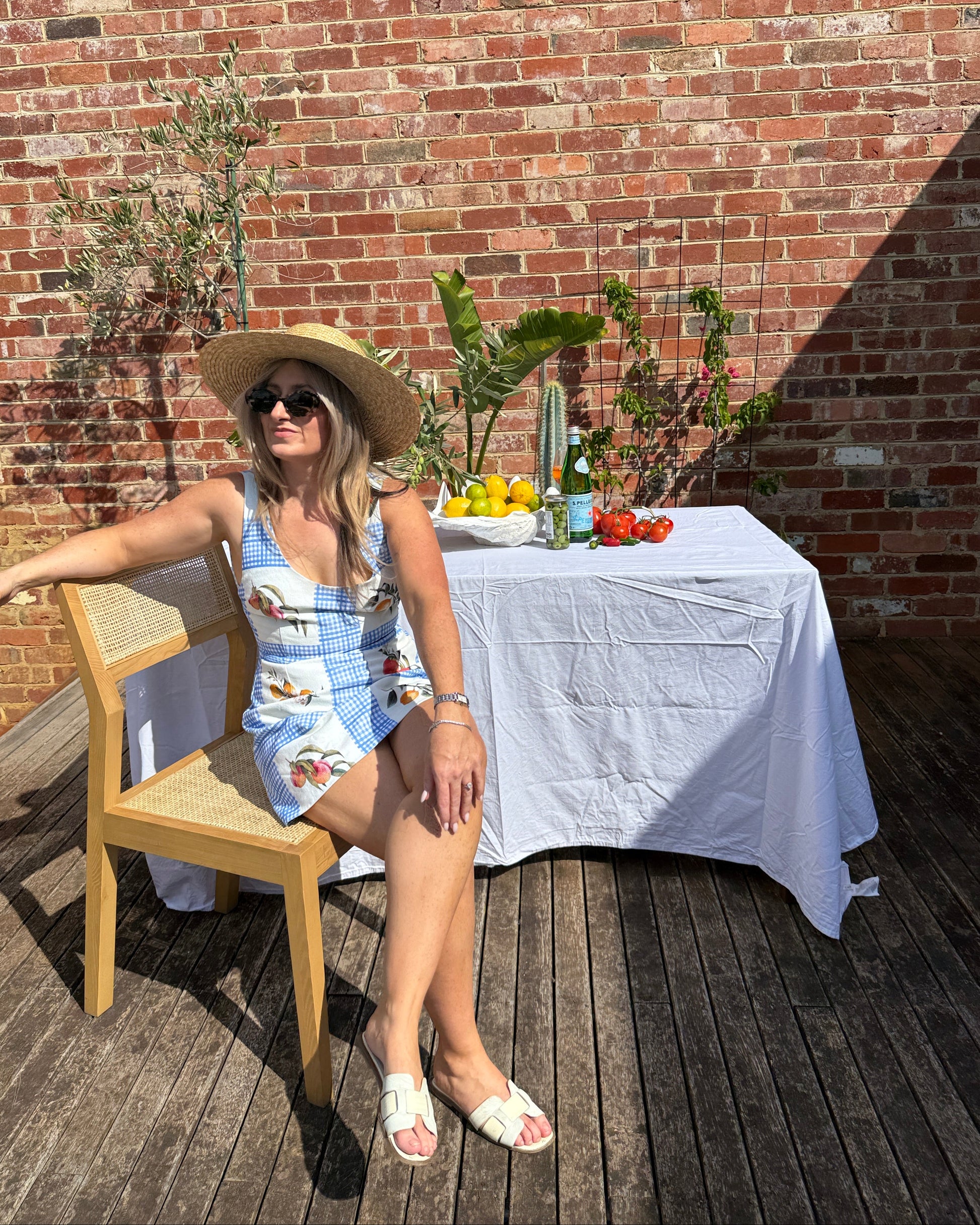European summer outfit featuring lemon print mini dress styled for long lunch and aperitivo