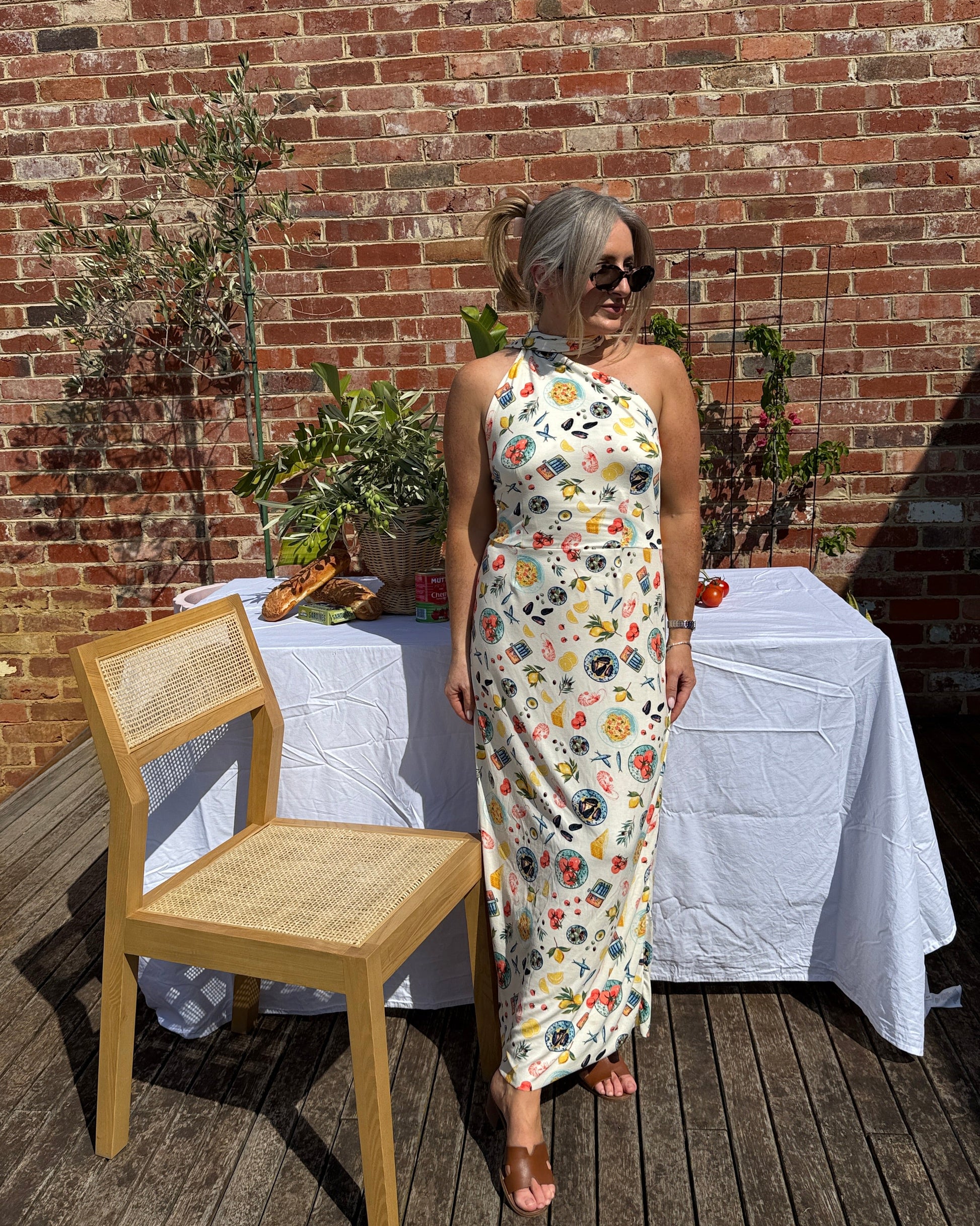 Resort wear maxi dress in seafood print styled for long lunch and aperitivo