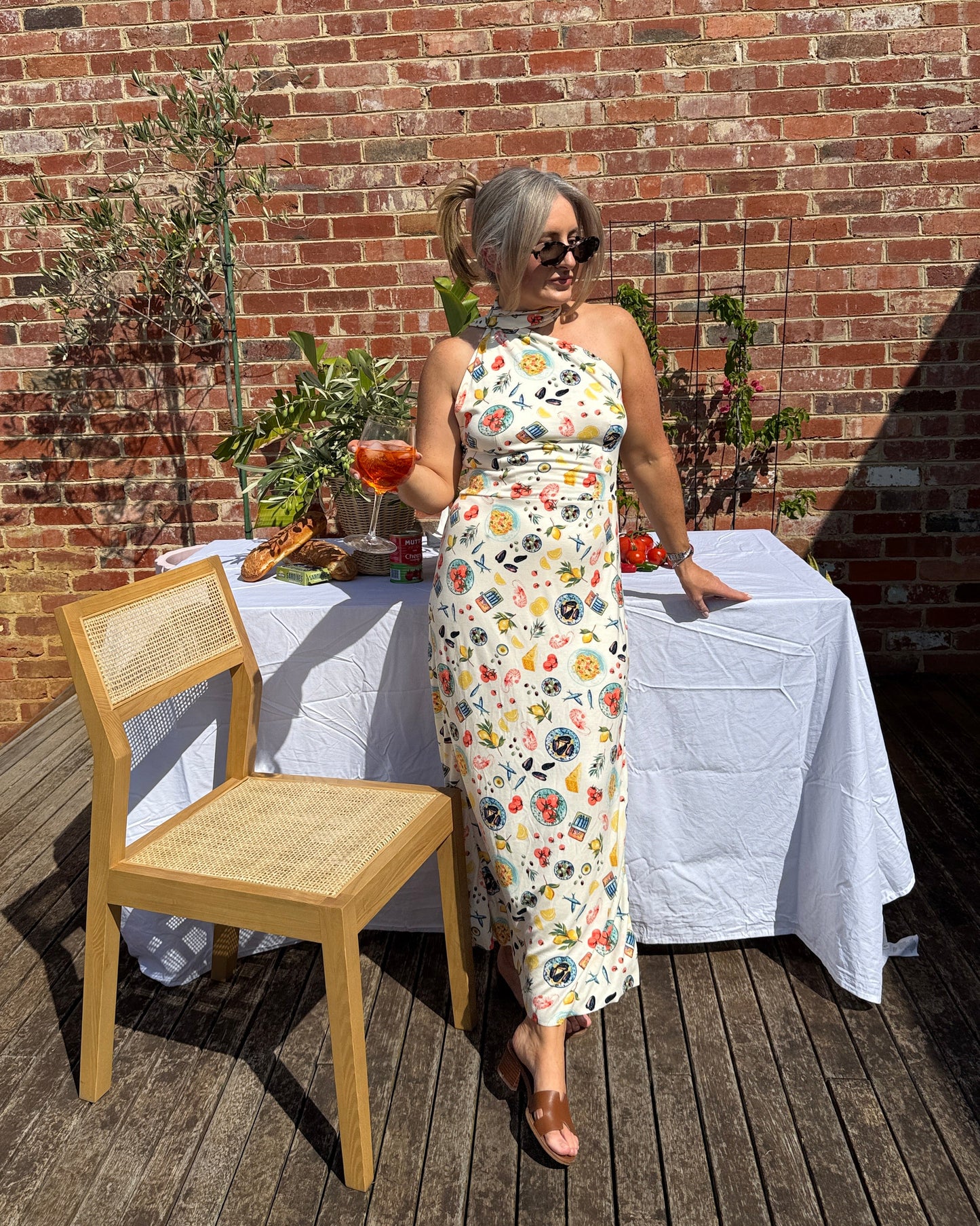 By Bel Sarinda one shoulder maxi dress in seafood print with long tie detail, styled for Mediterranean summer long lunch.