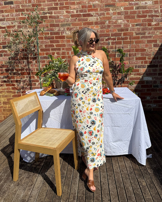 By Bel Sarinda one shoulder maxi dress in seafood print with long tie detail, styled for Mediterranean summer long lunch.