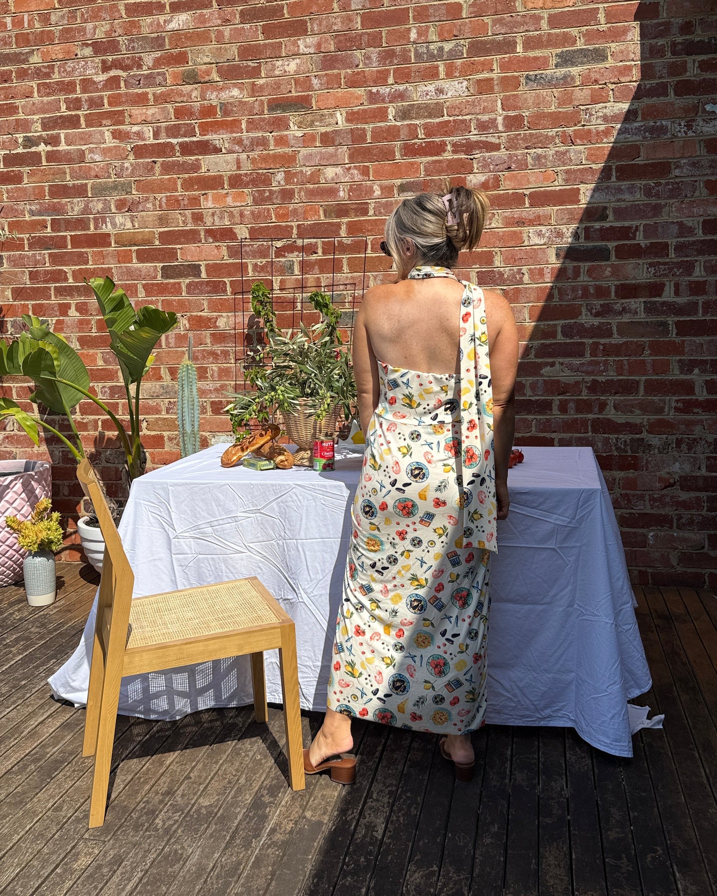 Back view of Sarinda one shoulder maxi dress by By Bel featuring flowing silhouette and seafood print for European summer styling.