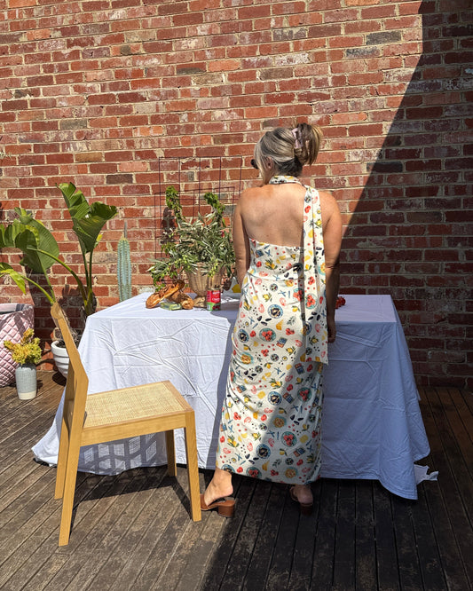 Back view of Sarinda one shoulder maxi dress by By Bel featuring flowing silhouette and seafood print for European summer styling.