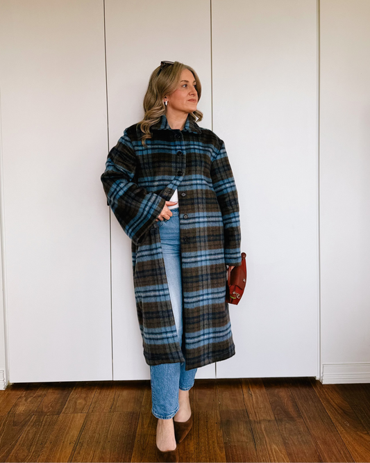 Model wearing The Tailored Coat by By Bel in an espresso and powder blue heritage check with a relaxed straight-cut silhouette