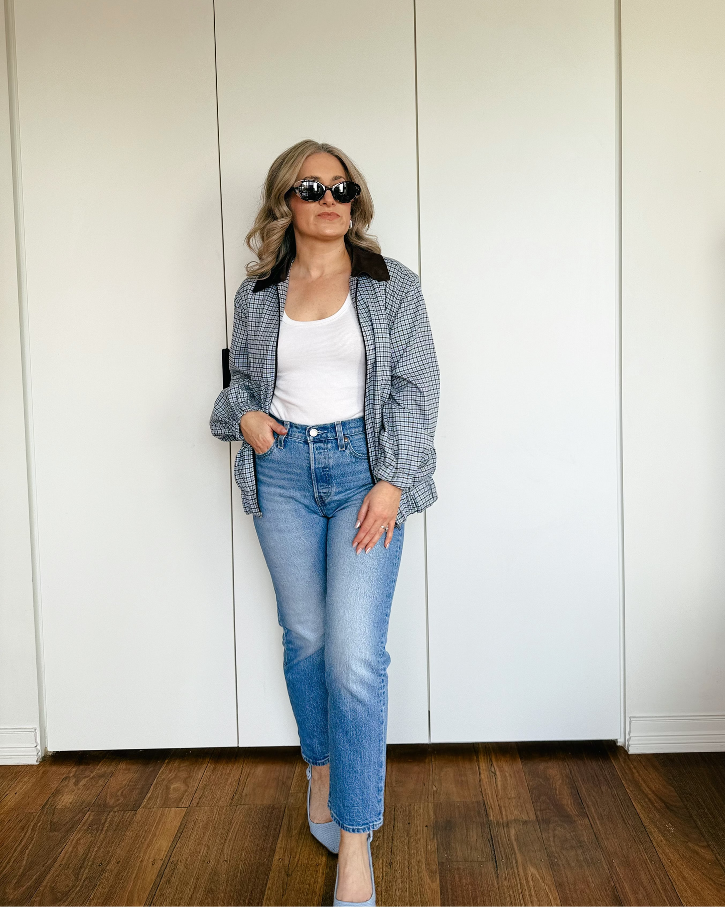 Model wearing The Tailored Bomber by By Bel in a powder blue heritage check with a contrast faux suede collar and relaxed silhouette.