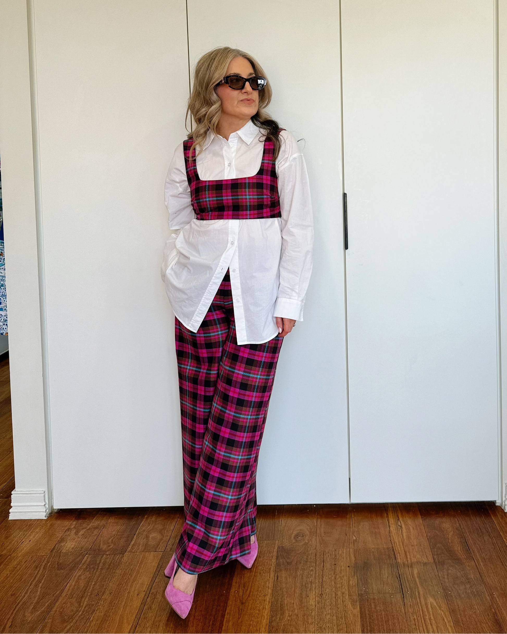 Model wearing The Tailored Crop by By Bel in a blush heritage tartan with a structured fit and square neckline.