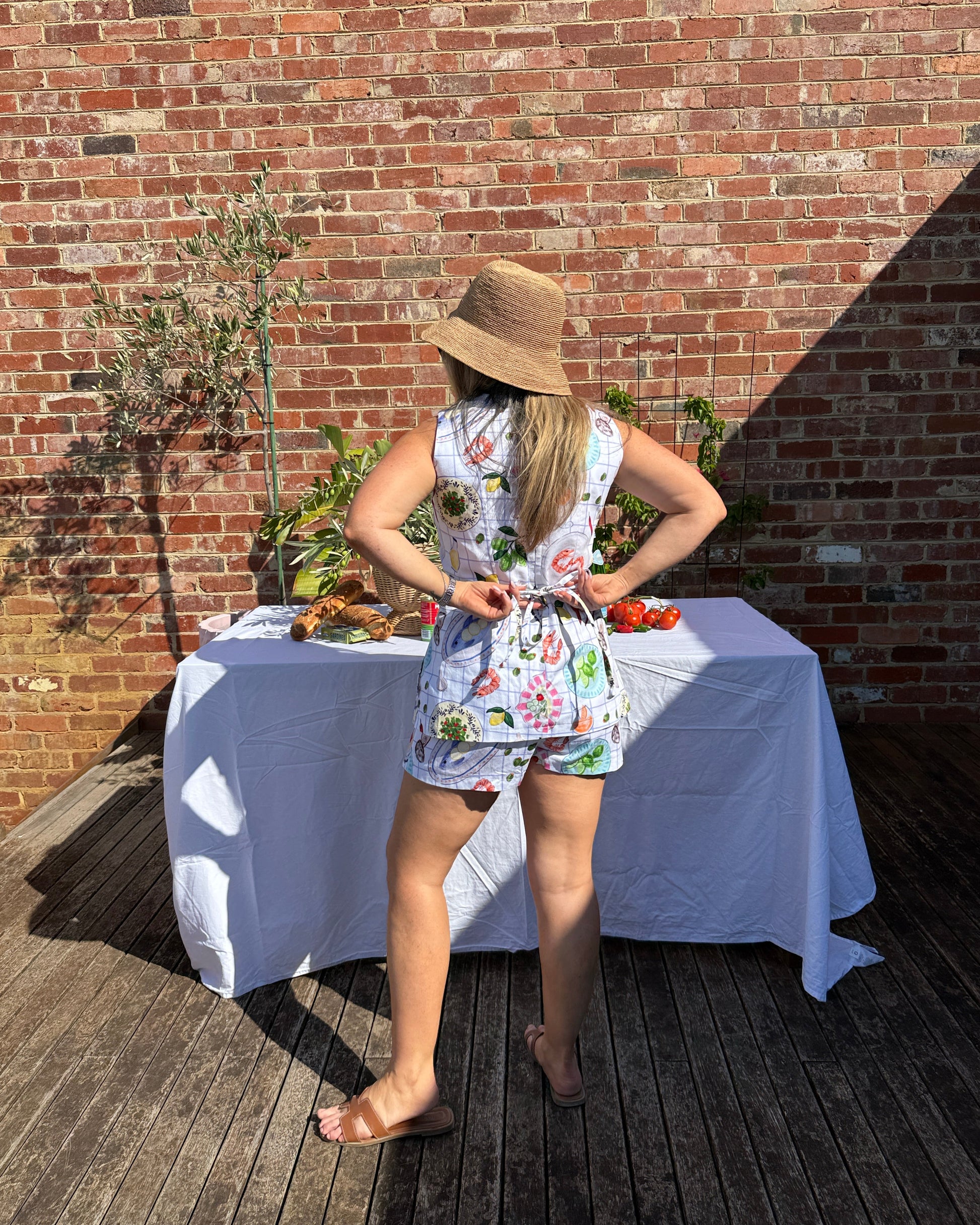 Tie back and flared hem detail on Mediterranean-inspired summer top