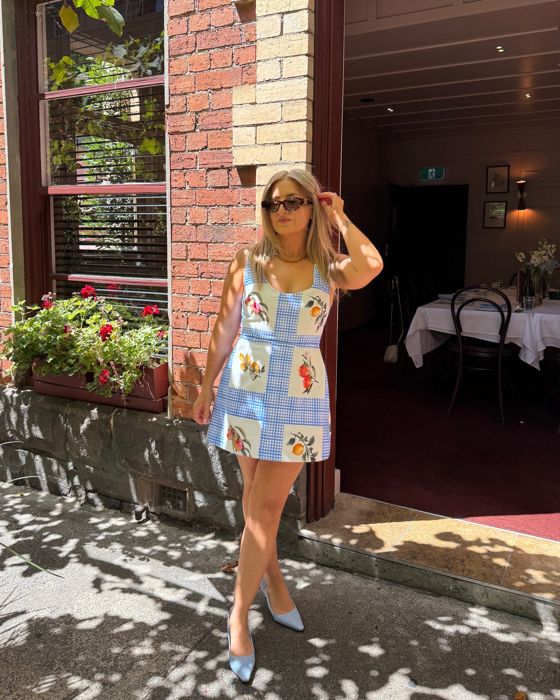 By Bel Limoncello lemon print mini dress with tailored silhouette and scoop neckline for Mediterranean summer styling