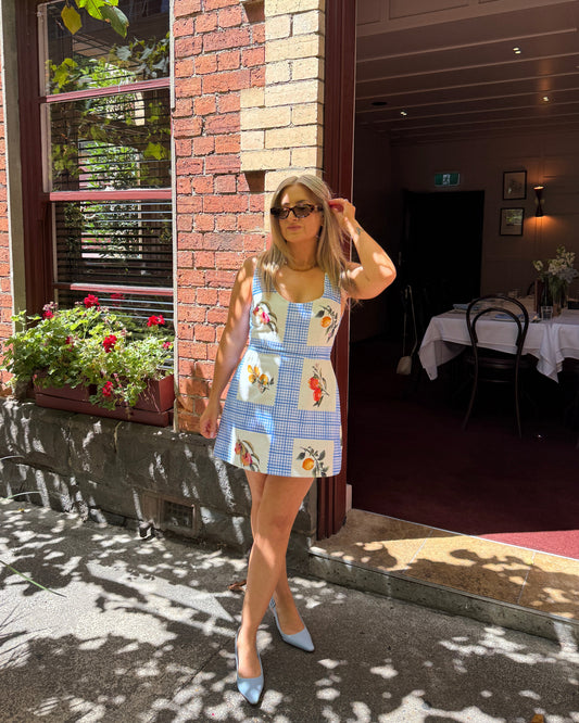 By Bel Limoncello lemon print mini dress with tailored silhouette and scoop neckline for Mediterranean summer styling