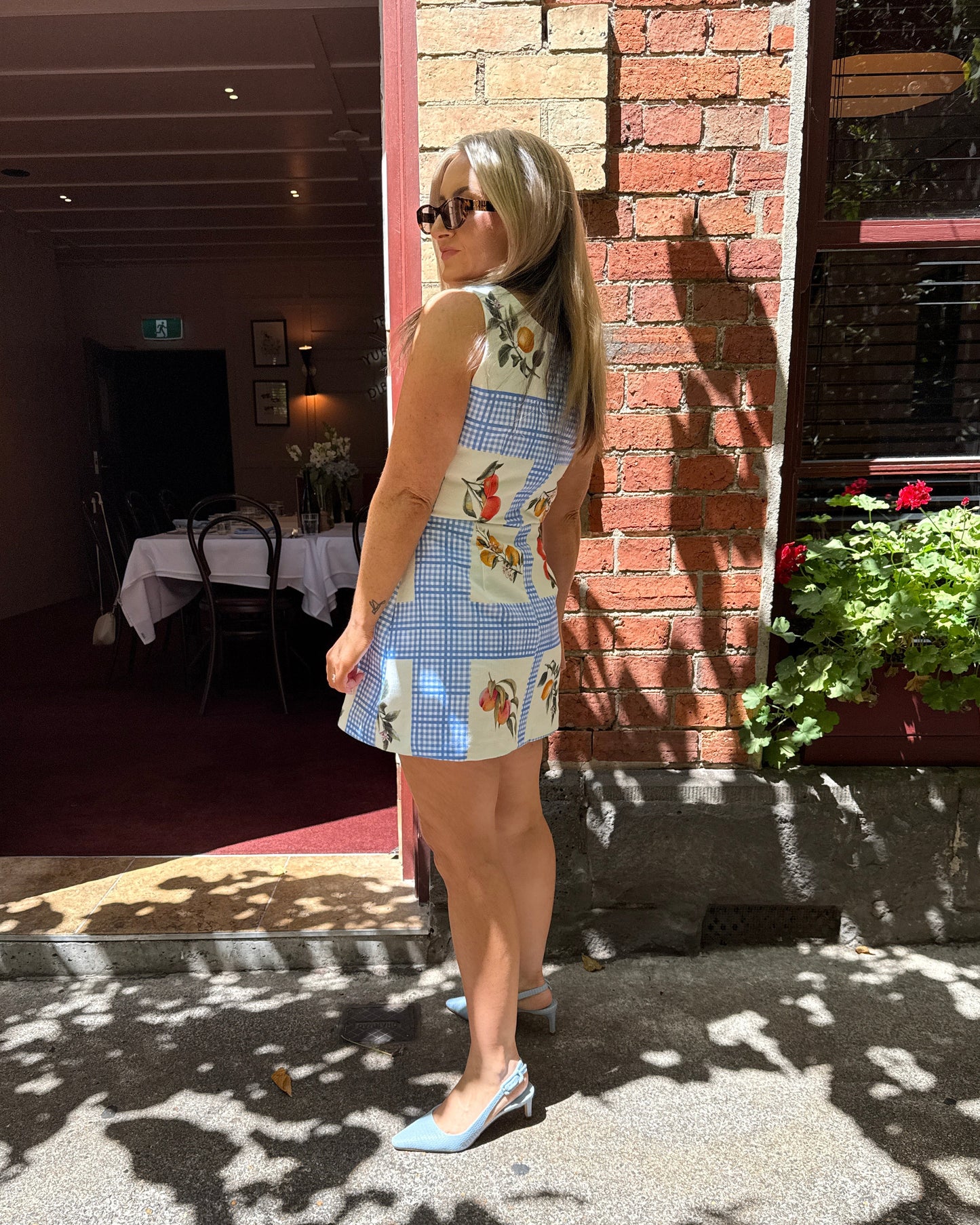 Lemon print summer mini dress by By Bel with structured cotton and gingham detail for European summer outfit